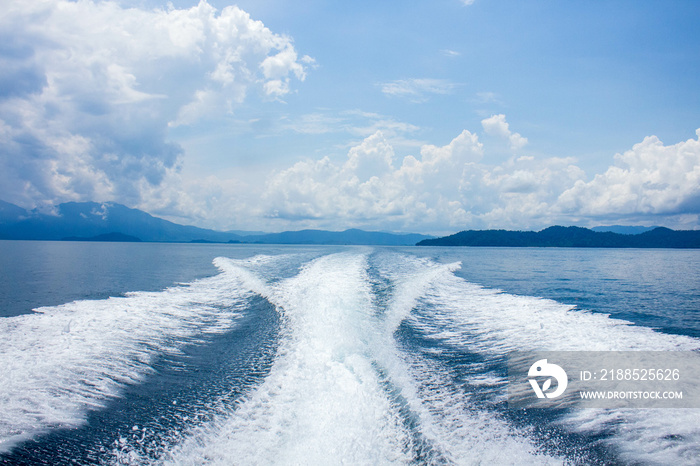 blue ocean sea water with speed boat wake foam in sunny day.