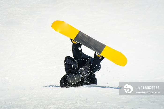 Male snowboarder on snowboard land on back in ski resort. Learning tricks and extreme ride downhill. Accidents on slopes in winter concept