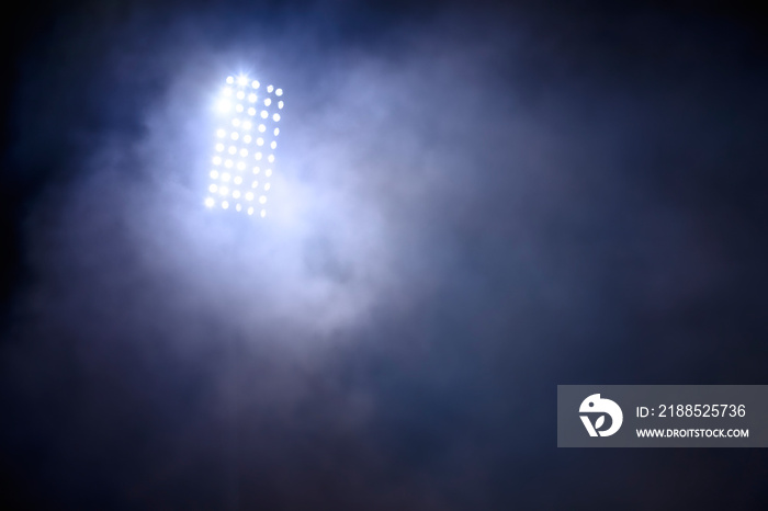 stadium lights and smoke against dark night sky background