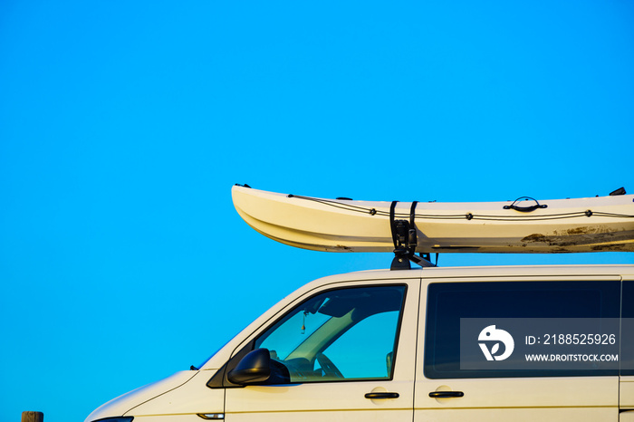 Canoe on roof top of car van