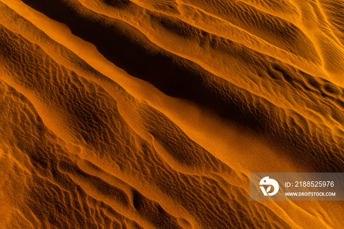 Close up orange sand texture in Empty Quarter Desert in United Arab Emirates. Sand dunes. Abstract sand texture.