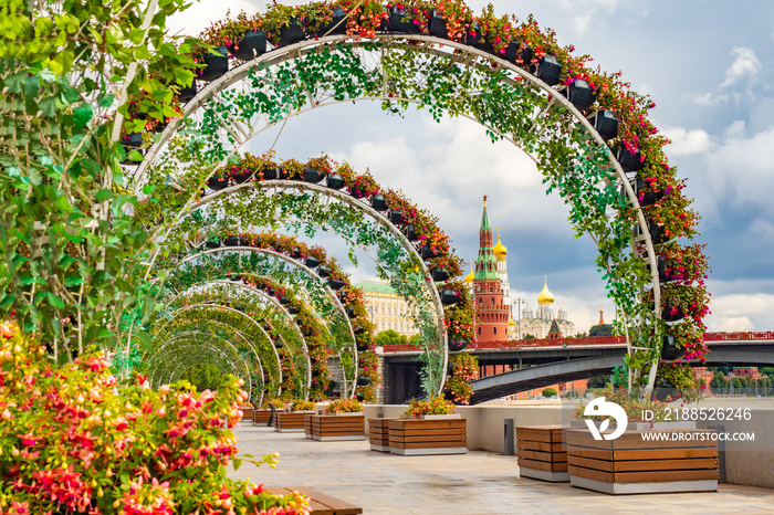 Moscow. Russia. View of the Kremlin from the embankment of the Moscow river. Arches of flowers and greenery in the center of Moscow. Summer decorations of the capital. Floral design.