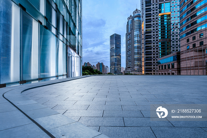 Empty square floor and city skyline with modern commercial buildings at night in Shanghai, China.