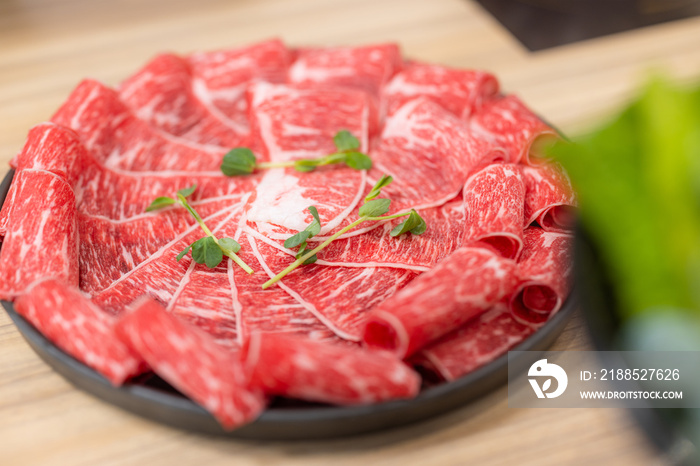 Slice of fresh raw beef at hot pot restaurant