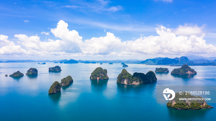 Thailand green lush tropical island in a blue and turquoise sea with islands in the background and clouds, Surrounding Islands of Koh Yao Noi, Phang Nga, Phang Nga, Thailand.