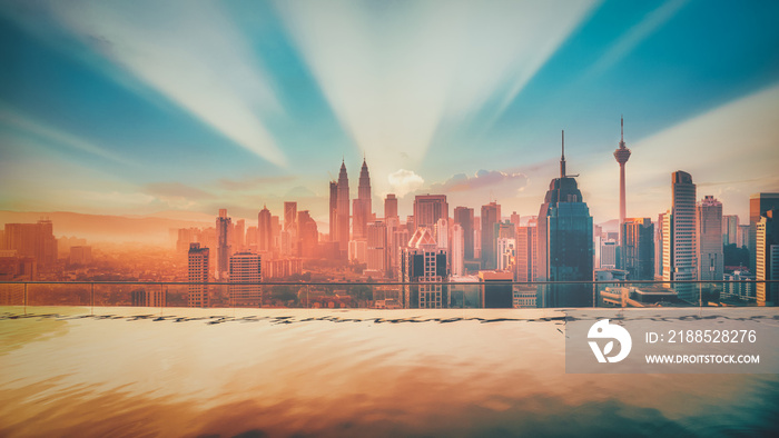 Cityscape of Kuala lumpur city skyline with swimming pool on the roof top of hotel at sunrise in Malaysia. Vintage tone