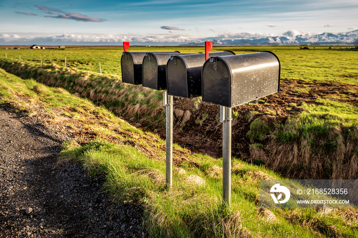 black metal mailboxes along a quiet country road