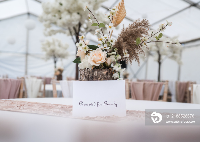 Reserved table sign reserved held for family only with flowers and handwritten message.