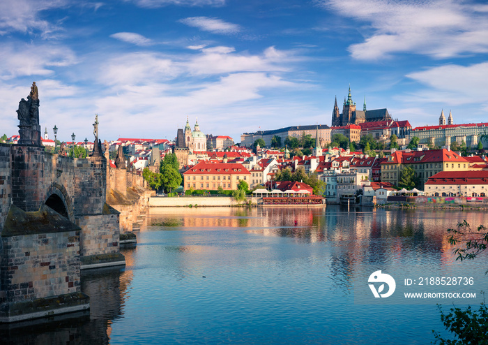 Colorful morning view of Charles Bridge, Prague Castle and St. Vitus cathedral on Vltava river