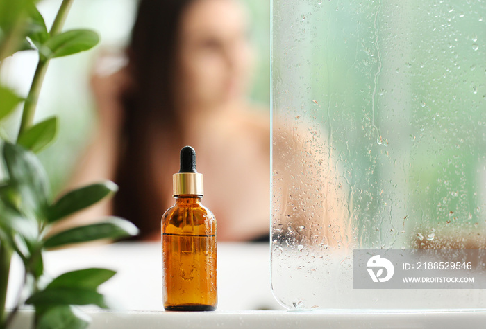 Bottle of essential oil in bathroom