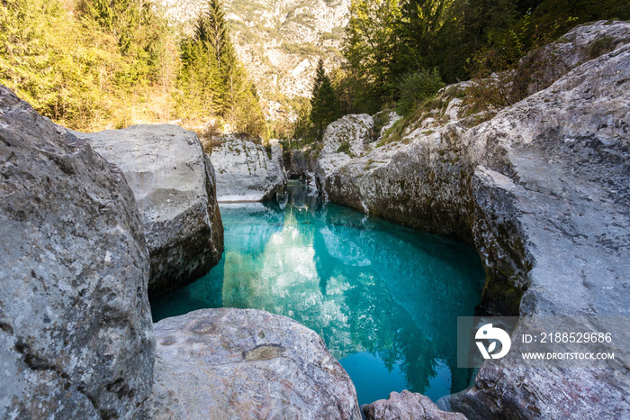 Impressive cliff and rocks at Soca River with crystal clear turquoise blue water. Kranjska Gora, Slovenia, Julian Alps, Soča, Vršič Pass