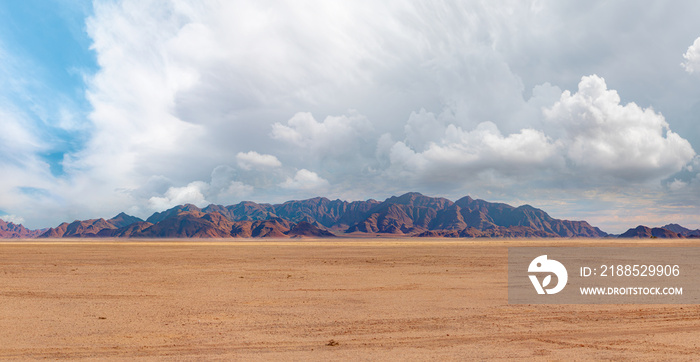 Panoramic view of desert plains in Namibia Africa with hills and mountains in the background