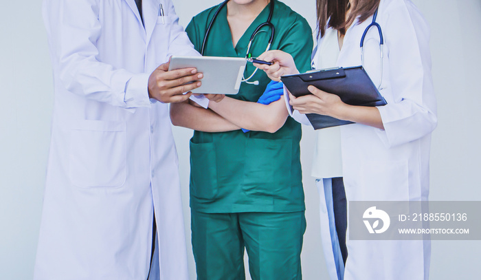 doctor and nurse checking patient information on a tablet device