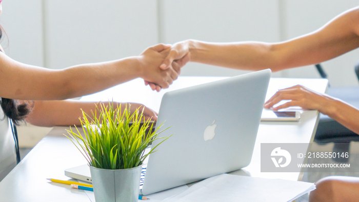 Close up lady hands shake with notebook at modern indoor office.