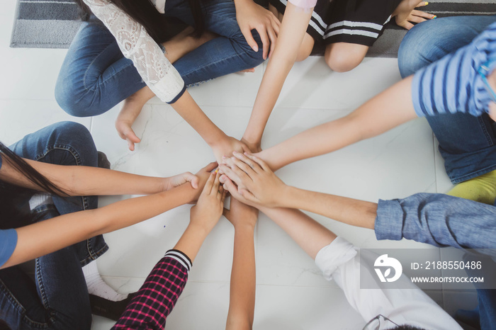 Group of student’s friendship and team work hand on hand