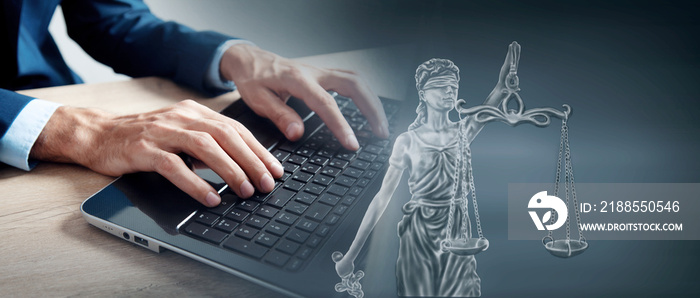 man in front of laptop and drawing of a statue of justice