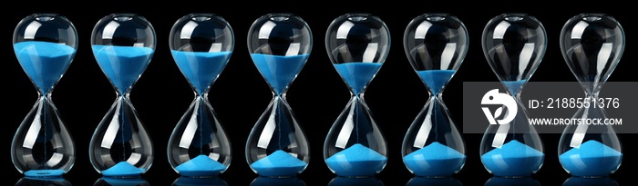 Collection of hourglasses with blue sand showing the passage of time