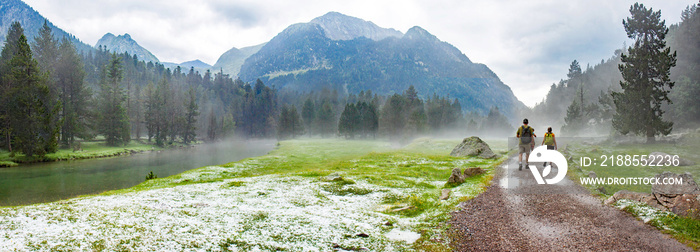 Aigues Tortes National Park, Catalunya, Spain; hikers in, soaked after a sudden hail storm on a warm summerday