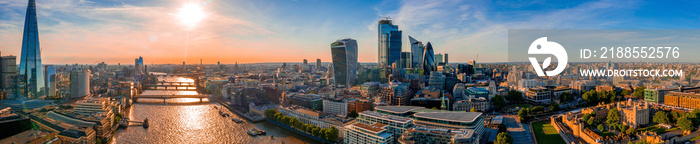 London rooftop aerial view at the morning light with urban architectures, modern skyscrapers like the Shard and city of London and Thames River by the Tower Bridge.