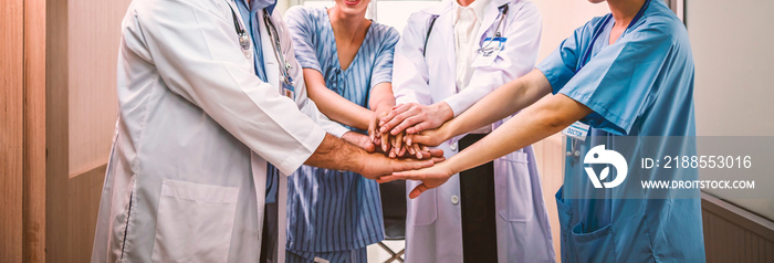 Doctors team joining hands as symbol of unity, teamwork concept.