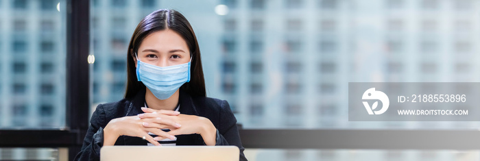 Asian women wear masks protect against airborne disease and salivary infections, during outbreak of Covid 19 virus (Coronavirus) in office, eye contact camera, copy space.