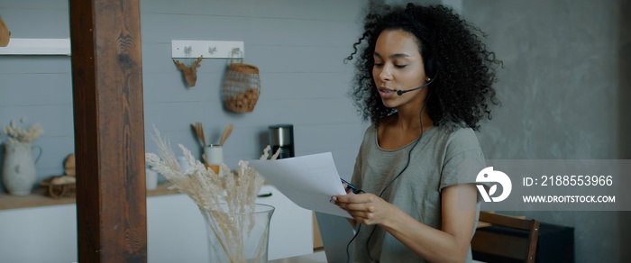 Black African American female working from home, having a phone call with client or office. WFH, stay home