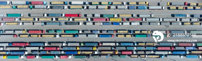 Aerial view of colorful trucks in the terminal waiting for unloading. Top view of the logistics center. Transportation. Freight transport, delivery. International road transport.