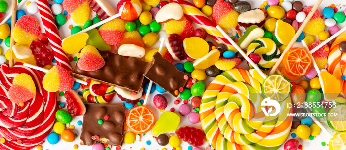 An assortment of colorful holiday sweets, panoramic orientation.