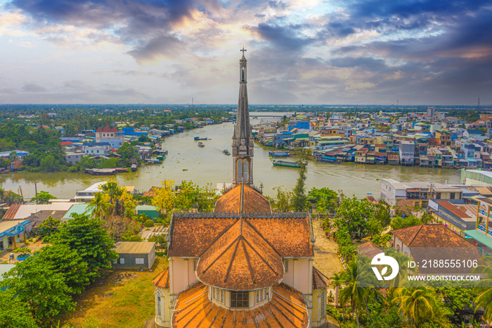 Aerial view of the famous Cai Be church in the Mekong Delta, Roman architectural style. In front is Cai Be floating market, Tien Giang, Vietnam.