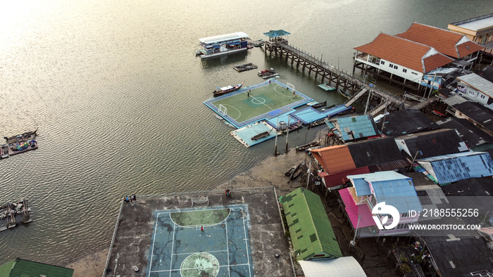 Ko Panyi - fishing village in Phang Nga Province, Thailand. Place built on stilts by Indonesian fishermen. Roofs of houses and floating football pitch.