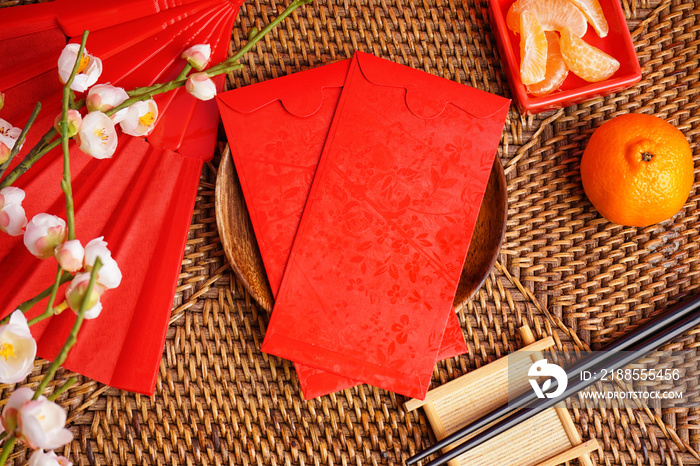 Table setting with red envelopes and Chinese symbols on wicker mat