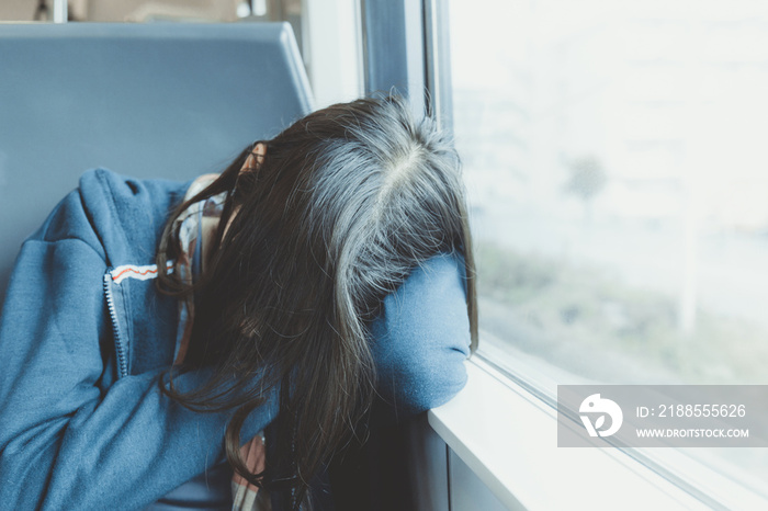 young traveler woman sleeping on the train or bus beside the win