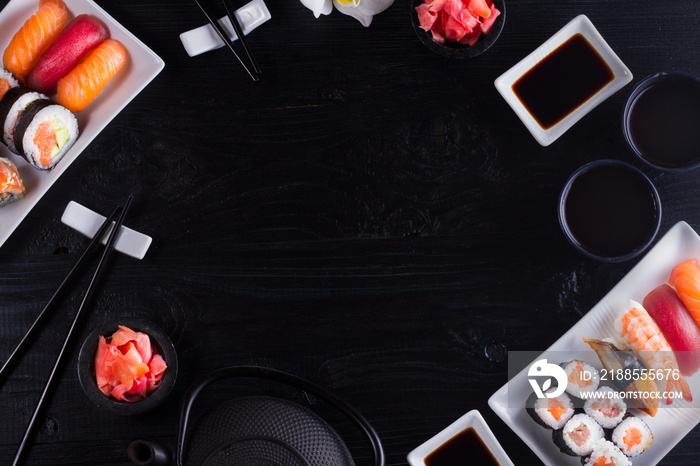 Japanese sushi dish scene on black wooden background with copy space