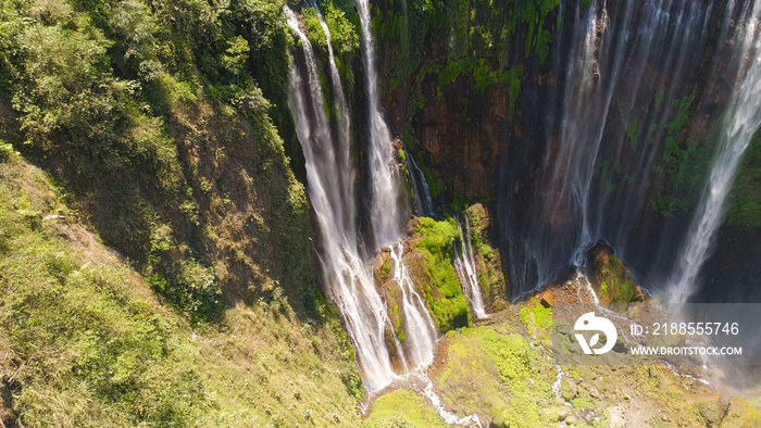 beautiful waterfall Coban Sewu in tropical forest, Java Indonesia. aerial view tumpak sewu waterfall in rainforest