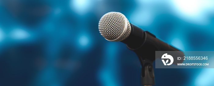 Microphone with stage light background for performance concept of speech comment and public speaking