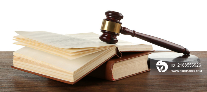 Gavel and books on wooden table on white background