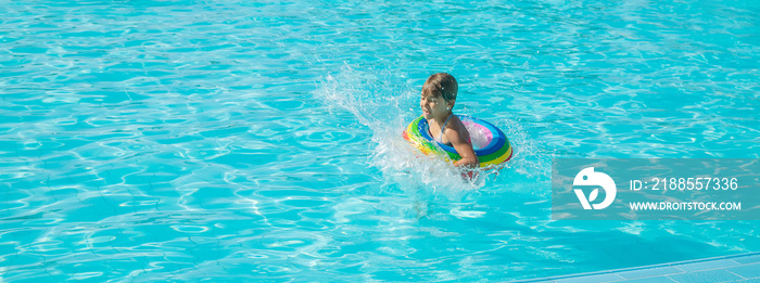 The child jumps into the pool. Selective focus.