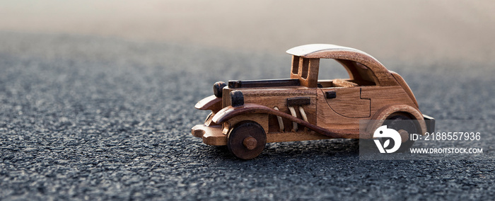 old retro wooden toy car on the road