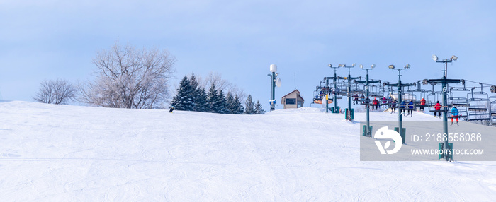 People are having fun in downhill skiing and snowboarding, panorama of ski lift