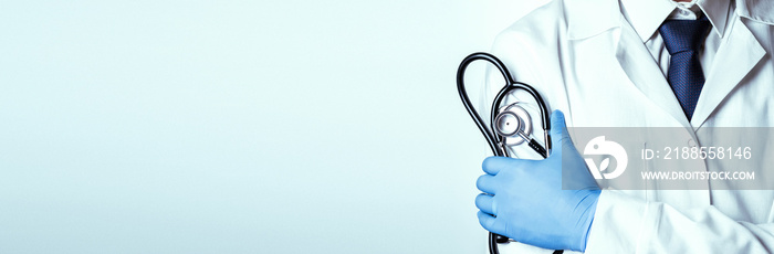 Stethoscope doctor medical background. Happy nurse in hospital uniform, blue gloves holding stethoscope isolated on white. Medicine service and healthcare concept.