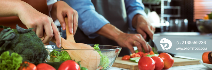 Young asian couple is preparing healthy food together and preparing for a happy lunch.