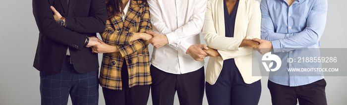 Conceptual background banner with multiracial men and women who work in one company standing together and holding hands. Team unity, corporate support, teamwork, business associates, community concept