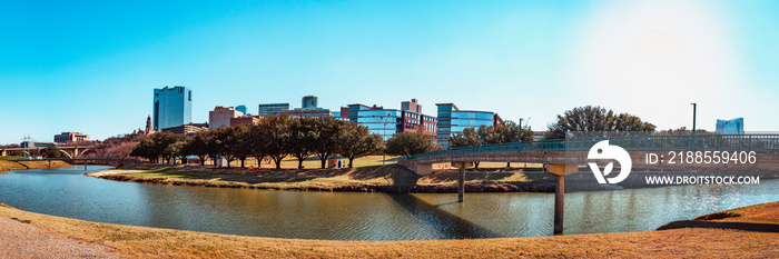 Fort Worth panoramic city skyline, buildings, and recreational park trails over the Trinity River Bridge