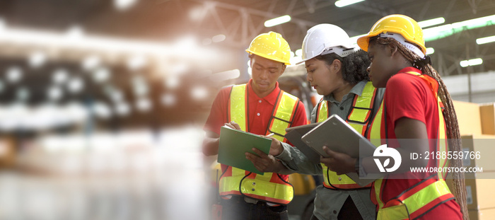 Team of professional engineers or foreman working and discussing together in the factory.