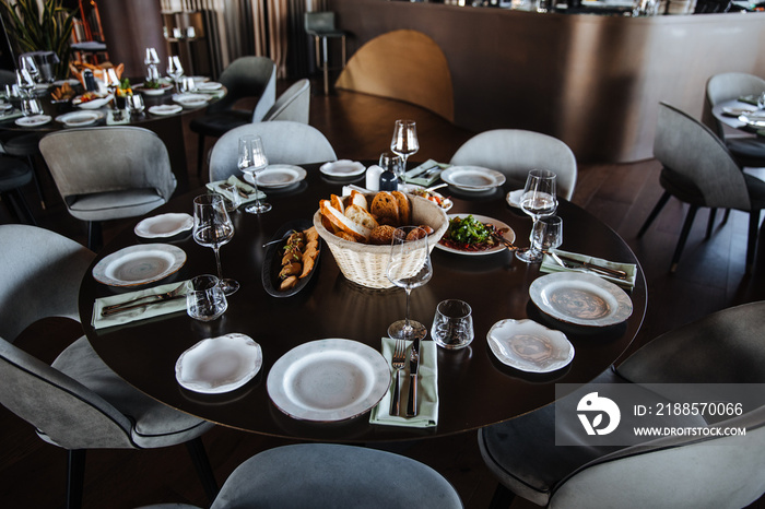 Beautifully organized event - round served table banquet ready for guests. Elegant dinner table