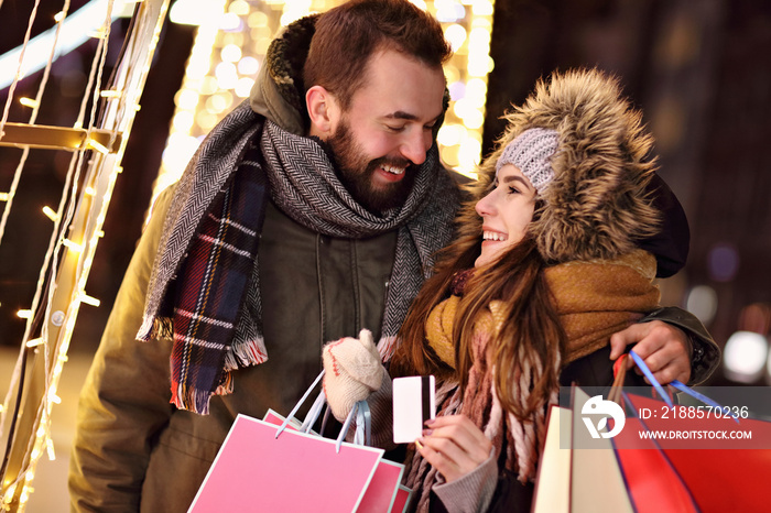 Adult couple shopping in the city during Christmas time