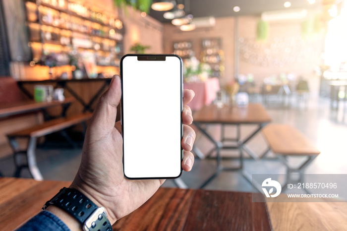 hand holding modern phone design with blank screen phone in cafe.