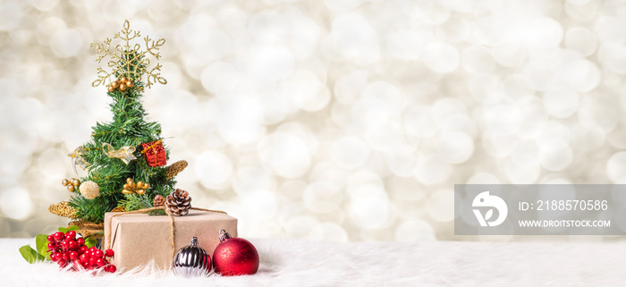 Christmas tree and gift box at blur bokeh light background,Winter holiday banner greeting card.
