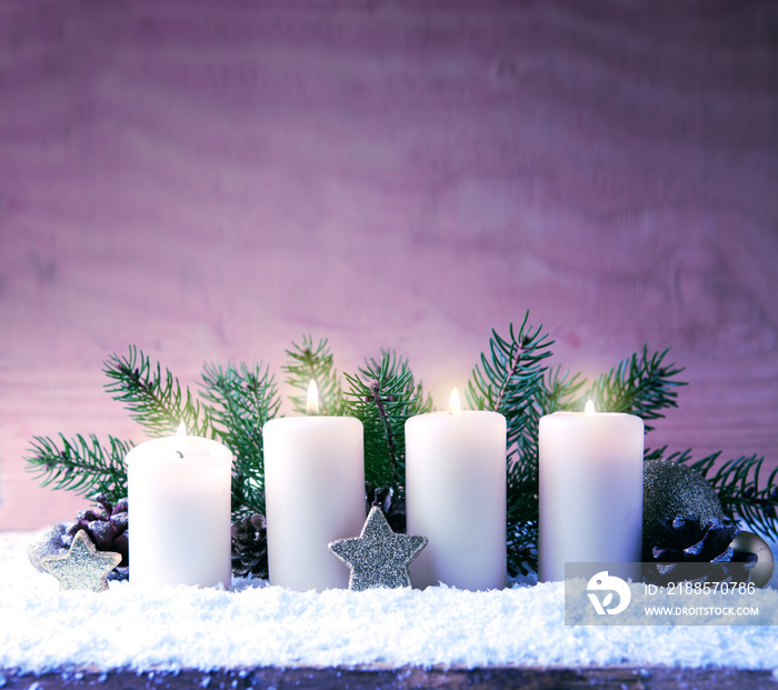 Four white burning advent candles isolated on wooden background.