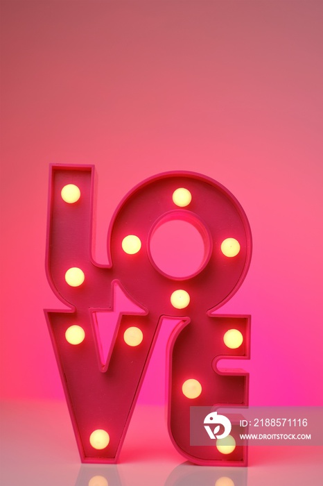 Love concept.Pink lettering love on a neon pink background.Relationships and feelings. Valentines D